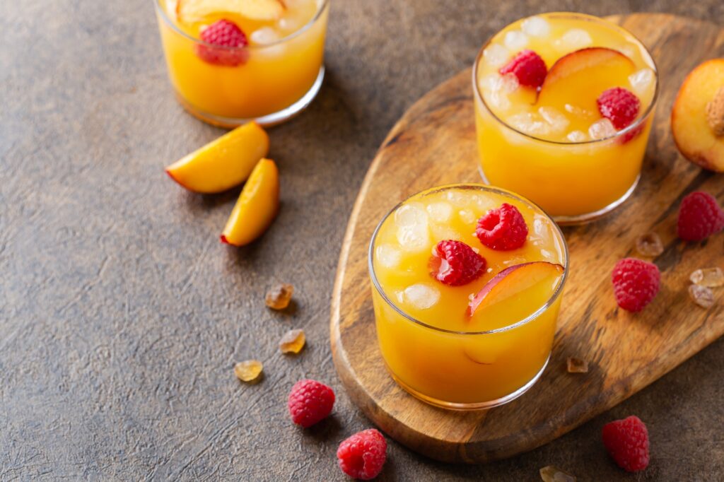Summer refreshing drink, beverage, cocktail with peach and raspberry